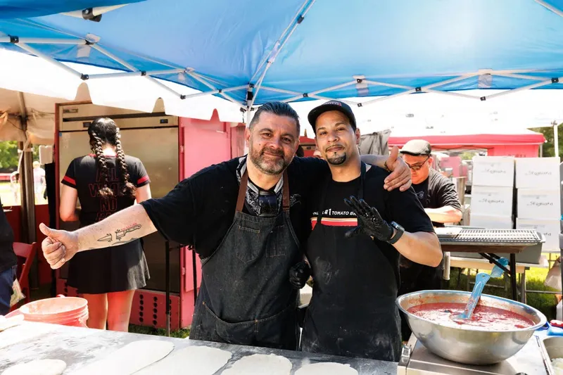 Two chefs posing at the dough station